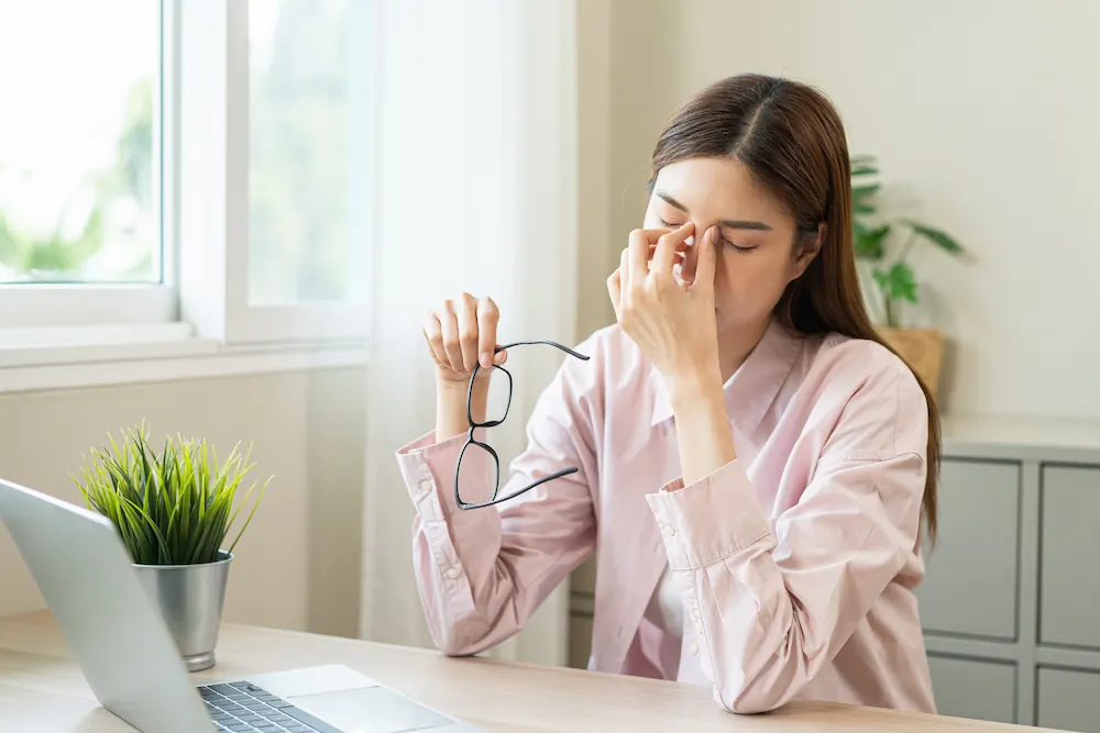 woman with hand to eye lids suffering from dry eyes woman with hand to eye lids suffering from dry eyes