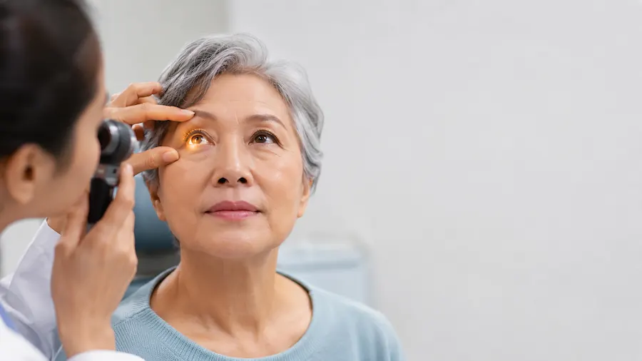 elderly woman getting an eye exam